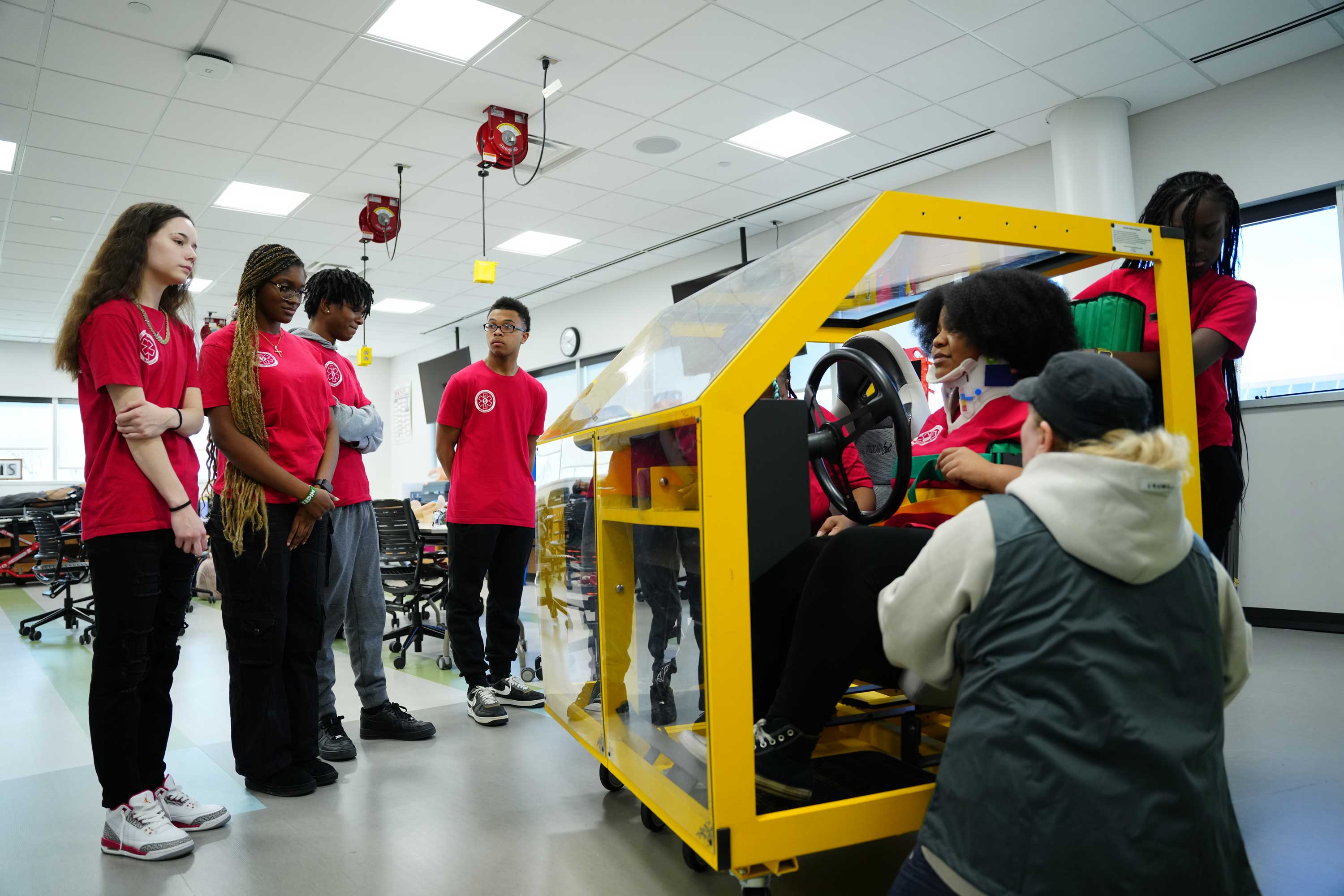 Students gather around a simulator.